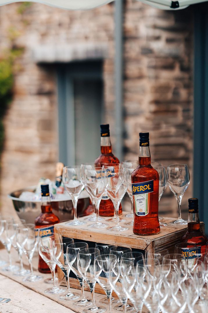 Aperol Spritz customised wedding cocktail idea on wooden crates for outdoor wedding bar design idea 