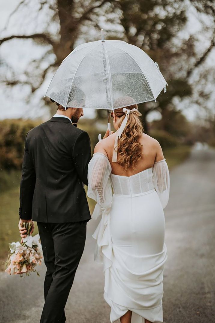 Bride and groom on their rainy wedding day protected by wedding insurance 