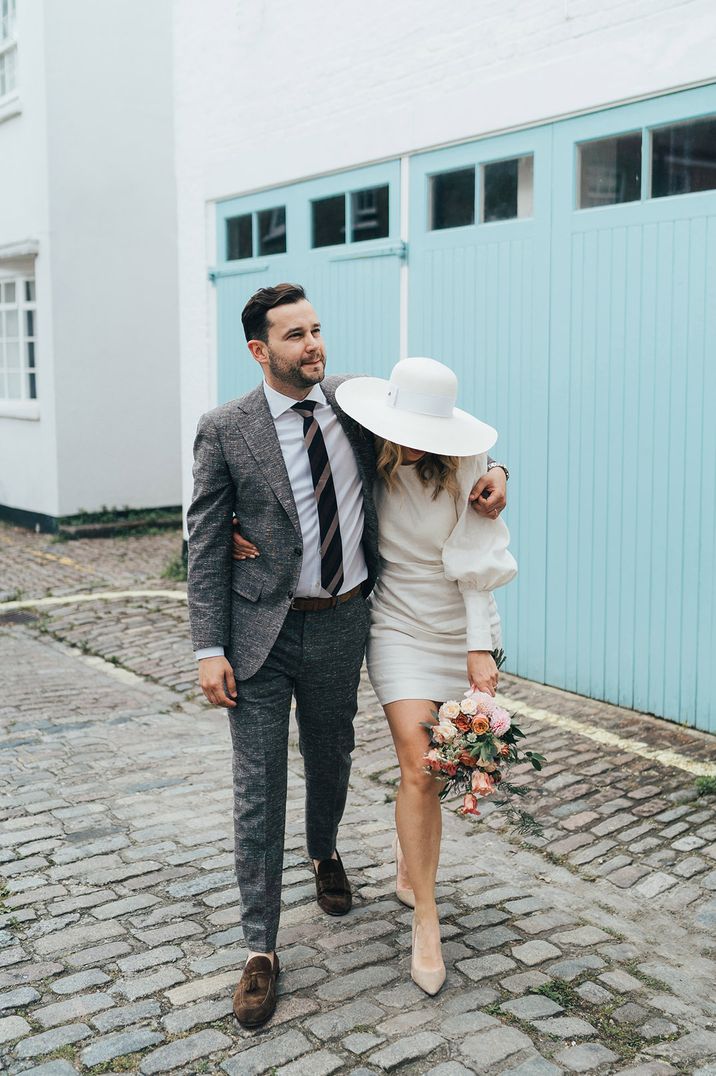 Bride in a short Net-a-Porter wedding dress with long sleeves 