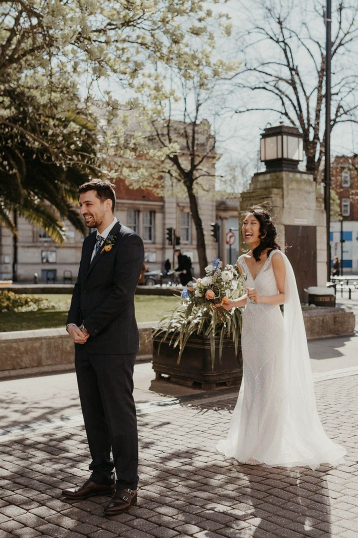 Bride approaches the groom from behind so they can react to each other for the first time 