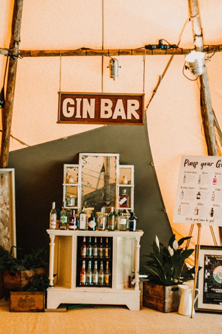 Themed wedding bar serving different brands of gin with different mixers and garnishes 