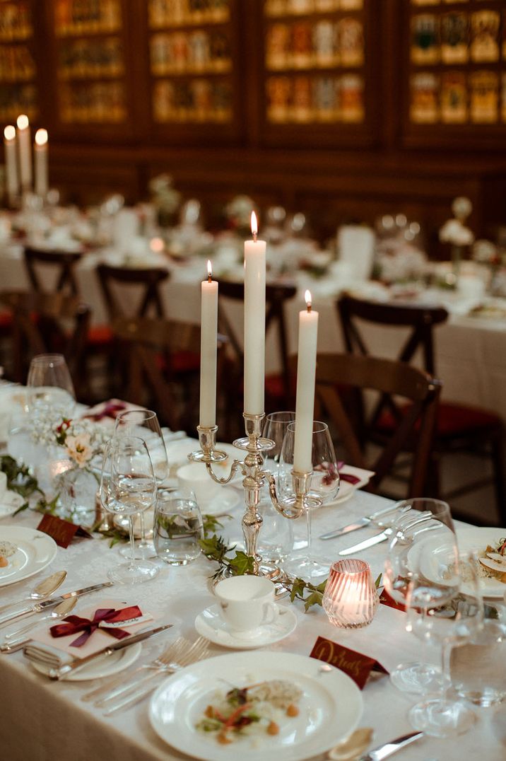 Inner Temple Hall vow renewal with white, silver and red theme with silver hardware, red ribbons and white flowers 