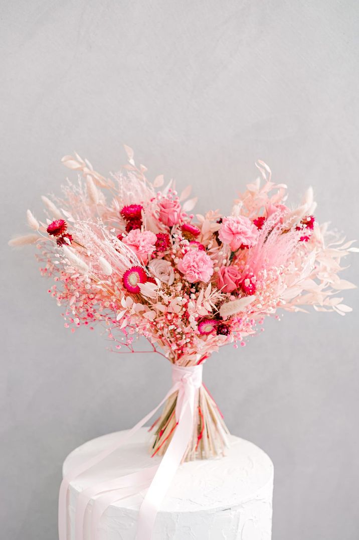 Bright pink and white flower wedding bouquet with gypsophila, roses, carnations and bunny grass 