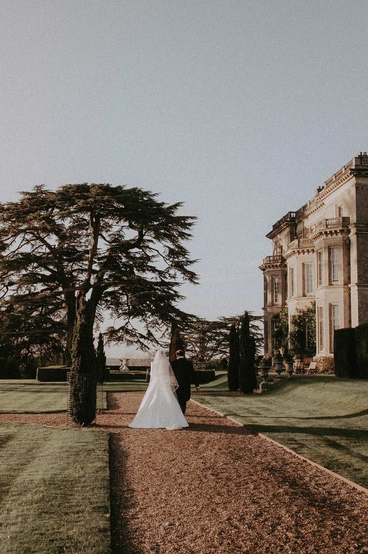 Couple walking the grounds at Hedsor House, eco wedding venues