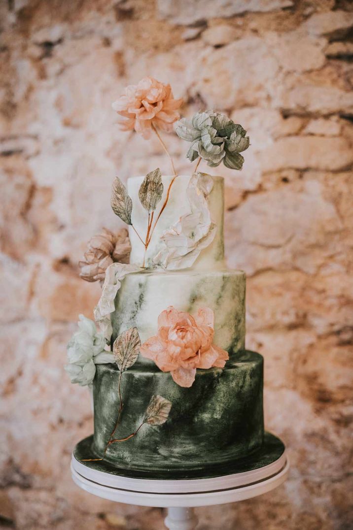 Three tiered green ombre wedding cake with delicate pink flower decorations