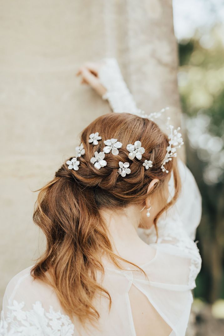 Bride wears floral styled hair accessories 