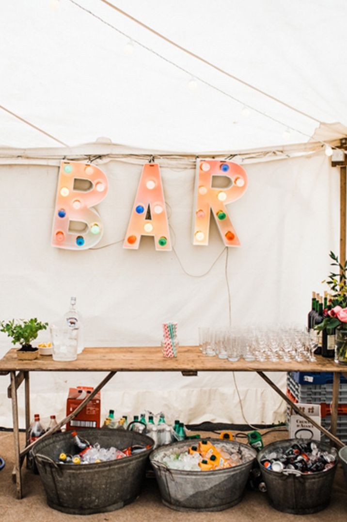 DIY wedding bar design ideas at marquee wedding reception and large sign 