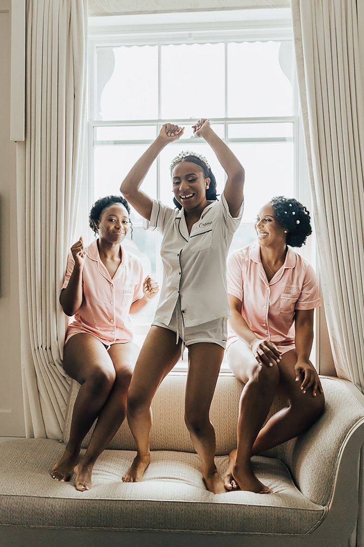 Hen party with bride in white satin pyjamas with hens in pink pyjamas 