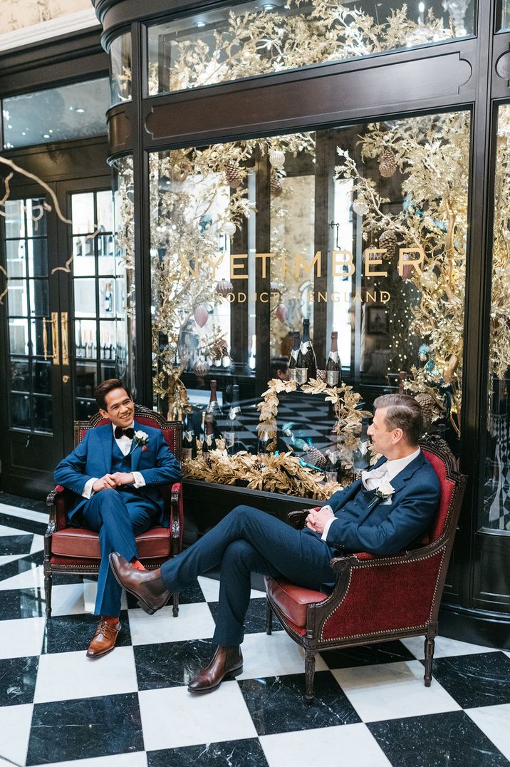 Grooms sit talking together for their elopement in London