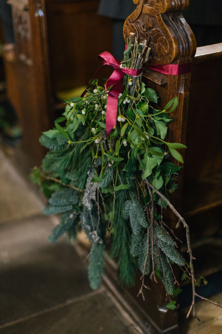 Mistletoe and foliage decoration with red ribbon for aisle decor 