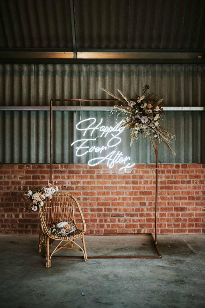 Happily ever after neon wedding sign with dried flower arrangements at The Giraffe Shed wedding venue