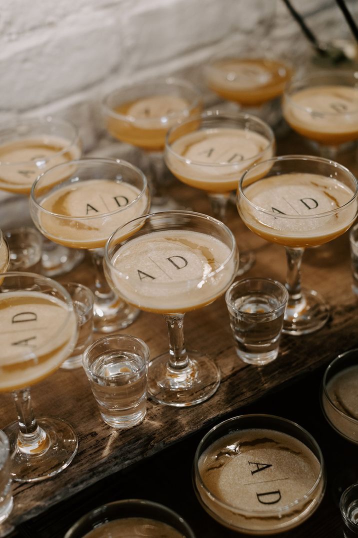 Pornstar martinis with custom drink toppers with the bride and groom's initials 