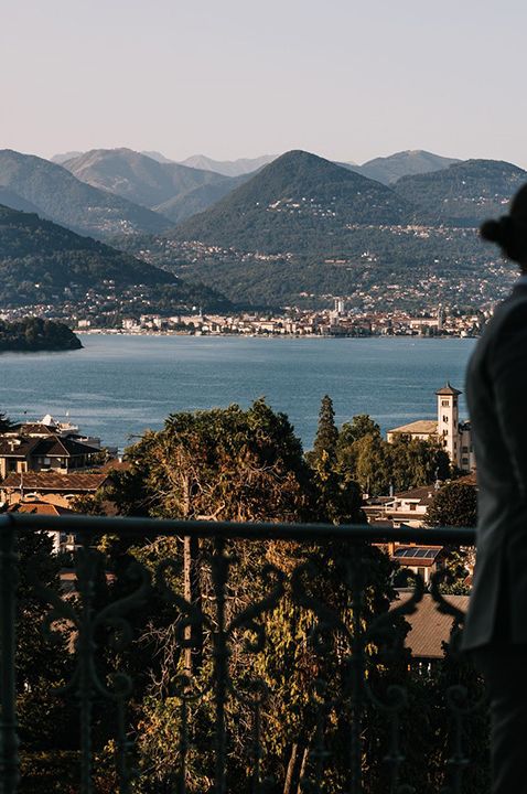 Villa Muggia - wedding venue in Italy - married couple looking out onto the lake - by Mcara Photography