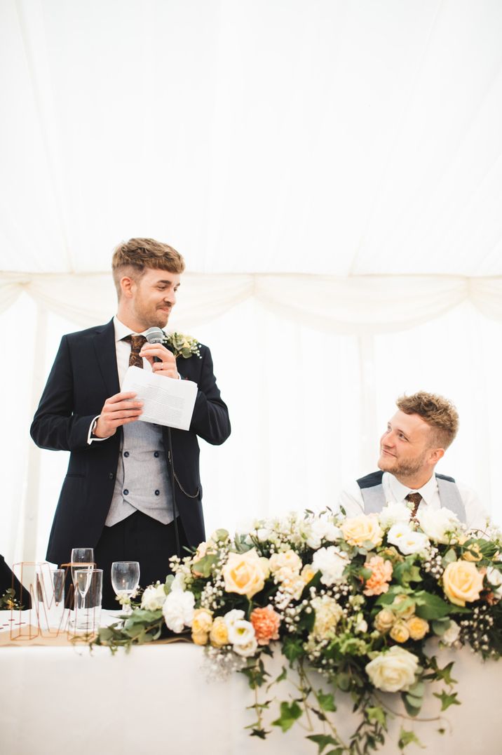 Wedding speeches between grooms in matching suits, perfect gay wedding inspiration 