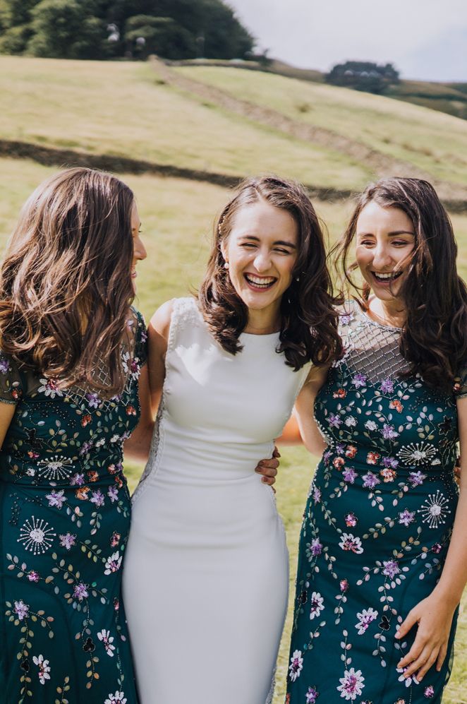 Bridal party portrait with bridesmaids in teal green embroidered dresses 