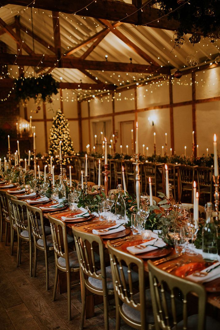 Orange and white wedding table setting with taper candles for soft lighting 