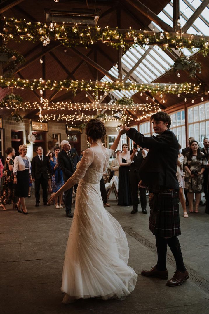 Rustic barn wedding at Errol Park with fairy lights wrapped around the beams