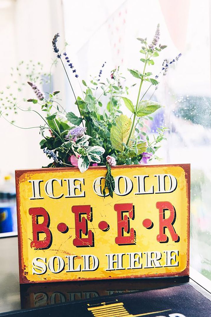 Yellow and red wedding sign that reads "ice cold beer sold here" captured by Mister Phill Photography