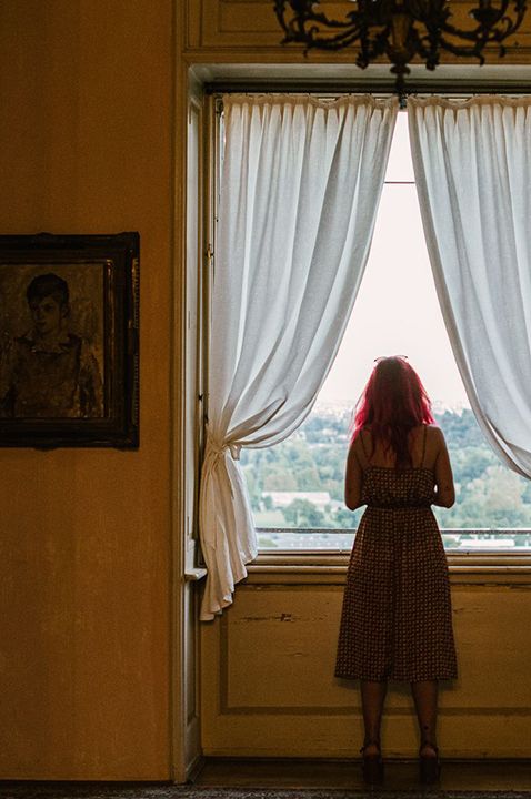  Le Due Torrette wedding venue in Italy - Woman looking out of window 