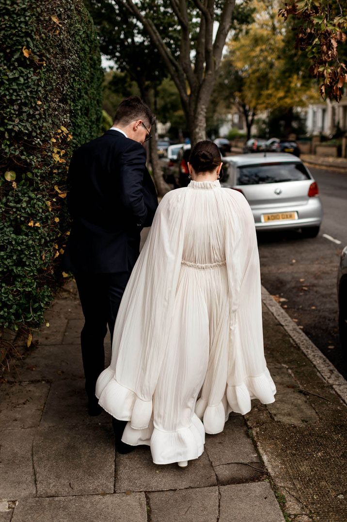 Bride wearing a flowing Lanvin wedding dress with groom in a blue suit 