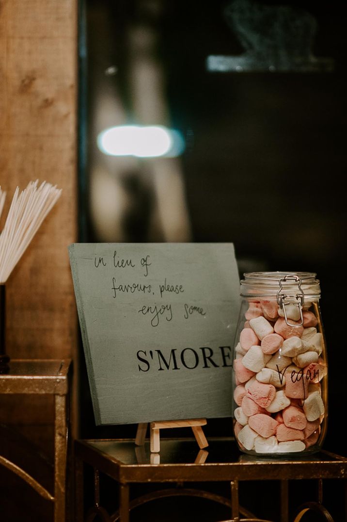 A unique wedding s'mores station for the guests to eat instead of traditional favours 