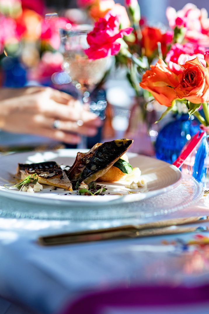 Oven-roasted hake fillet, yellow split peas, chorizo, tomato and clams for traditional plated formal dining wedding breakfast 