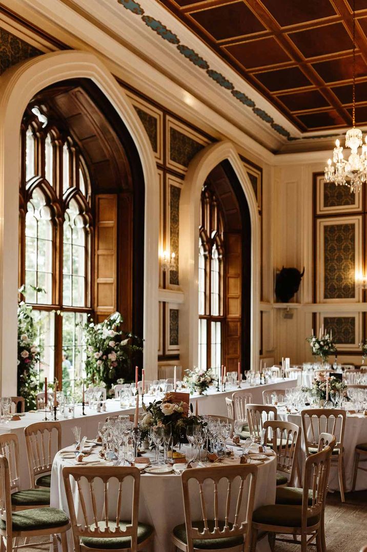 Reception room of Drumtochty Castle wedding venues Scotland with classic wedding tablescapes and chandeliers 