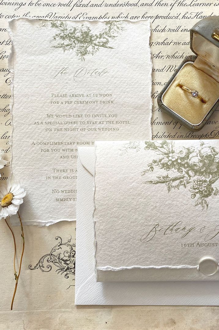 Aged wedding invitation with ripped edges and floral design with envelope and wax seal 