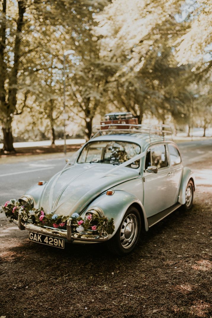 Vintage baby blue VW Beetle with floral decorations