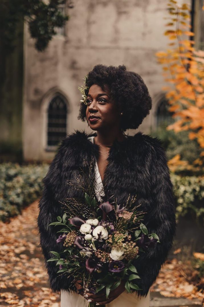 Bride wears black faux fur cover up with long sleeves