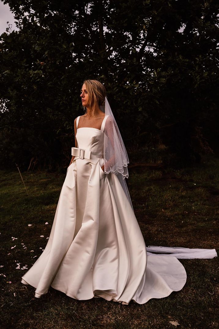 Bride in a Jesus Peiro wedding dress with full skirt and bow detail 