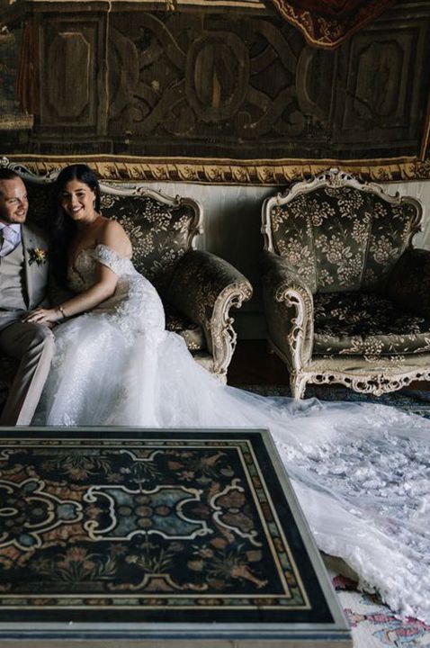 Villa Muggia - wedding venue in Italy - married couple sitting on a luxe couch in venue's opulent interior - by Mcara Photography