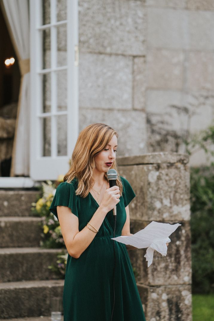 Person making wedding speech in green velvet short-sleeved dress 