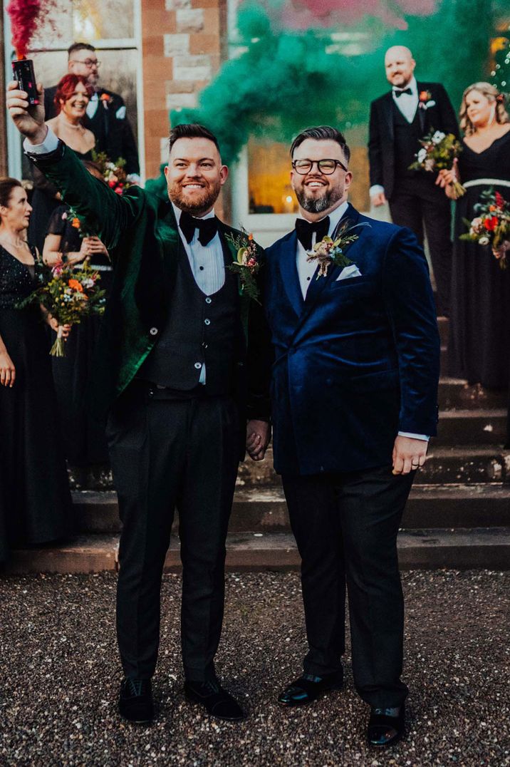 Grooms in colourful velvet suit jackets and matching black bow ties serve as gay wedding inspiration