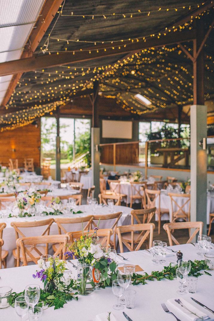 Rustic wedding reception venue complete with hanging fairy lights