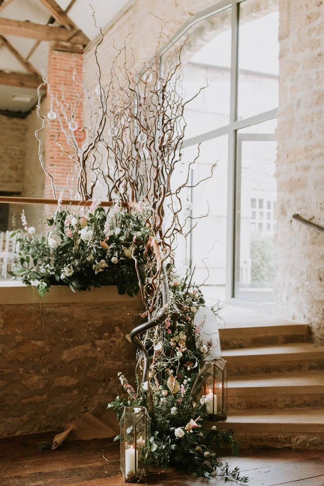 Floral arrangement display with foliage, neutral toned flowers and twigs at Hooton Pagnell Hall