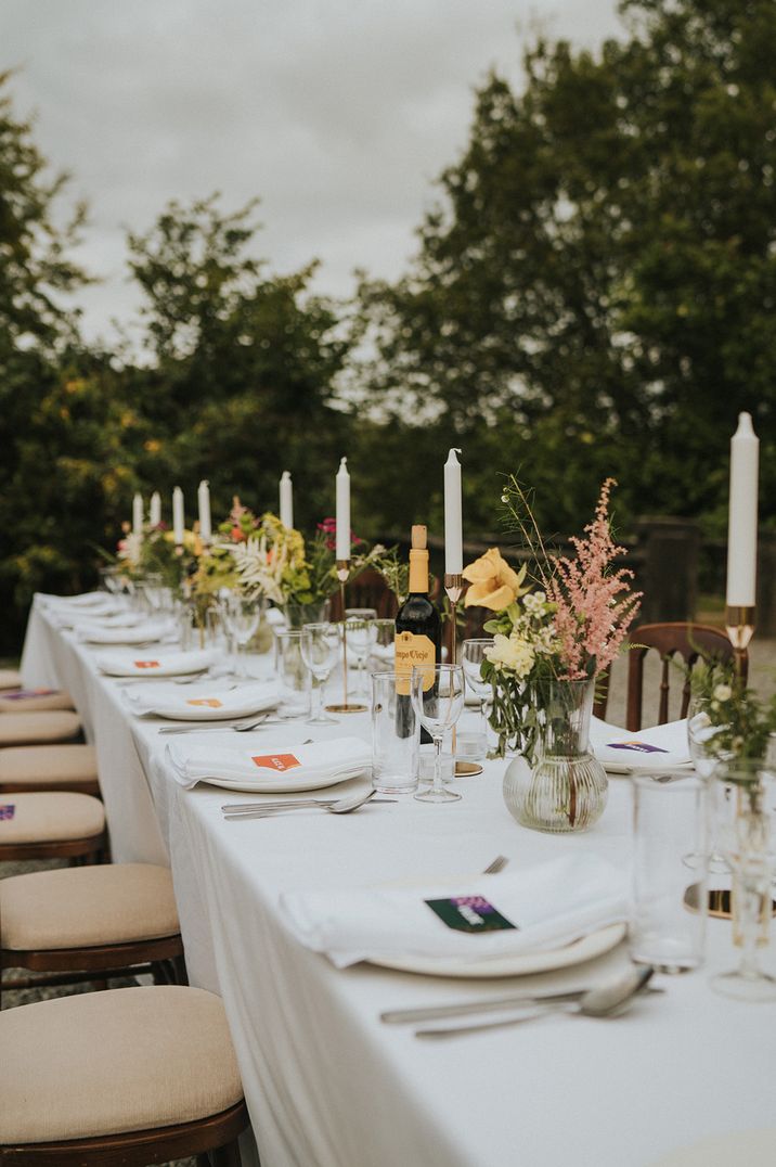 Outdoor wedding reception at Colehayes Park with taper candles and flowers in vases 