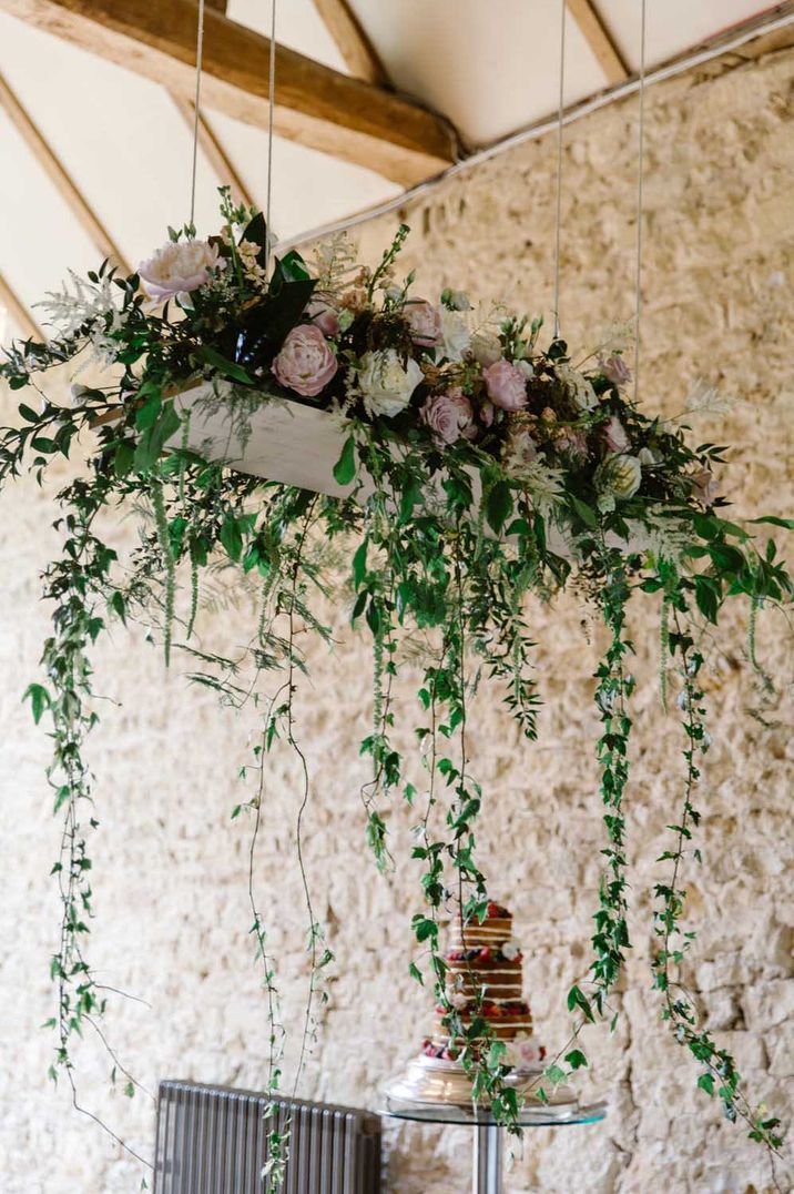 Hanging Neutral Toned Roses and Green Foliage Wedding Decor at Notley Abbey - Best Black Friday Wedding Deals 2023