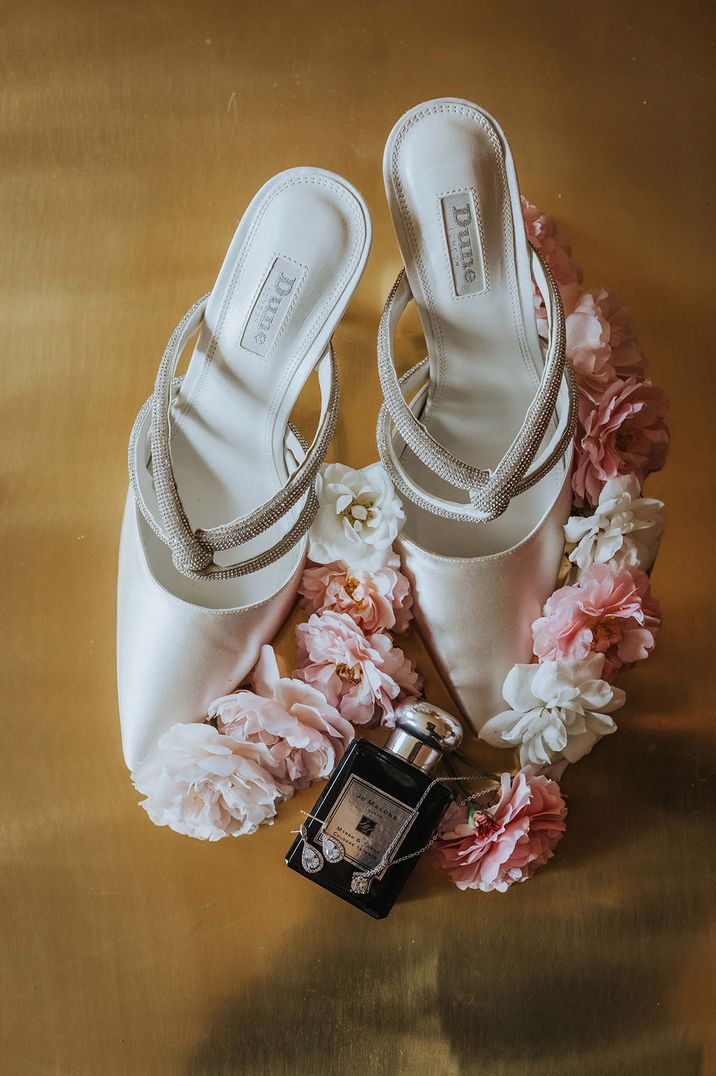 Myrrh & Tonka wedding scent by Jo Malone with the white Dune wedding shoes and pink flowers bridal accessories photo 