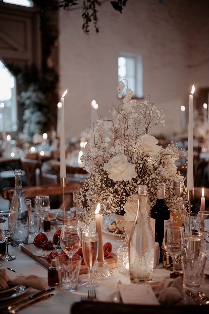 The wedding tables are decorated with white wedding flowers and white table name signage at winter wedding venue 