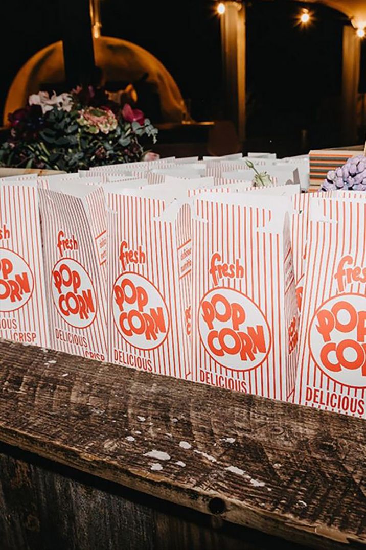 Retro cardboard boxes of popcorn for a movie night stag party idea 