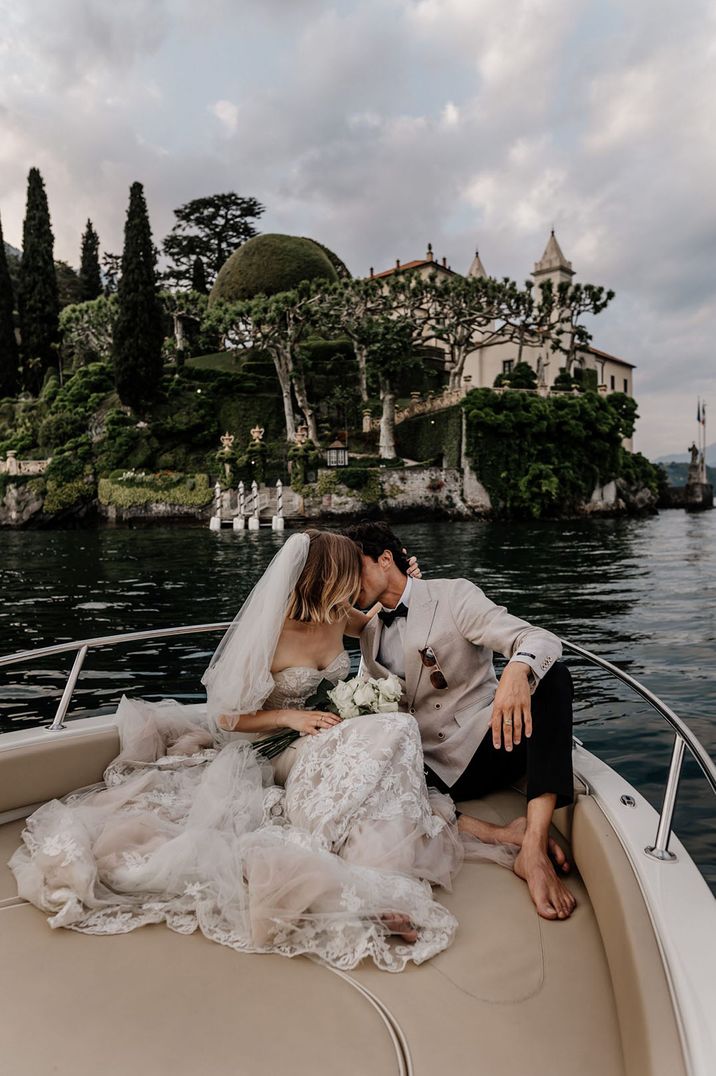 Bride and groom kissing on a boat at their Lake Como wedding elopement in Italy 