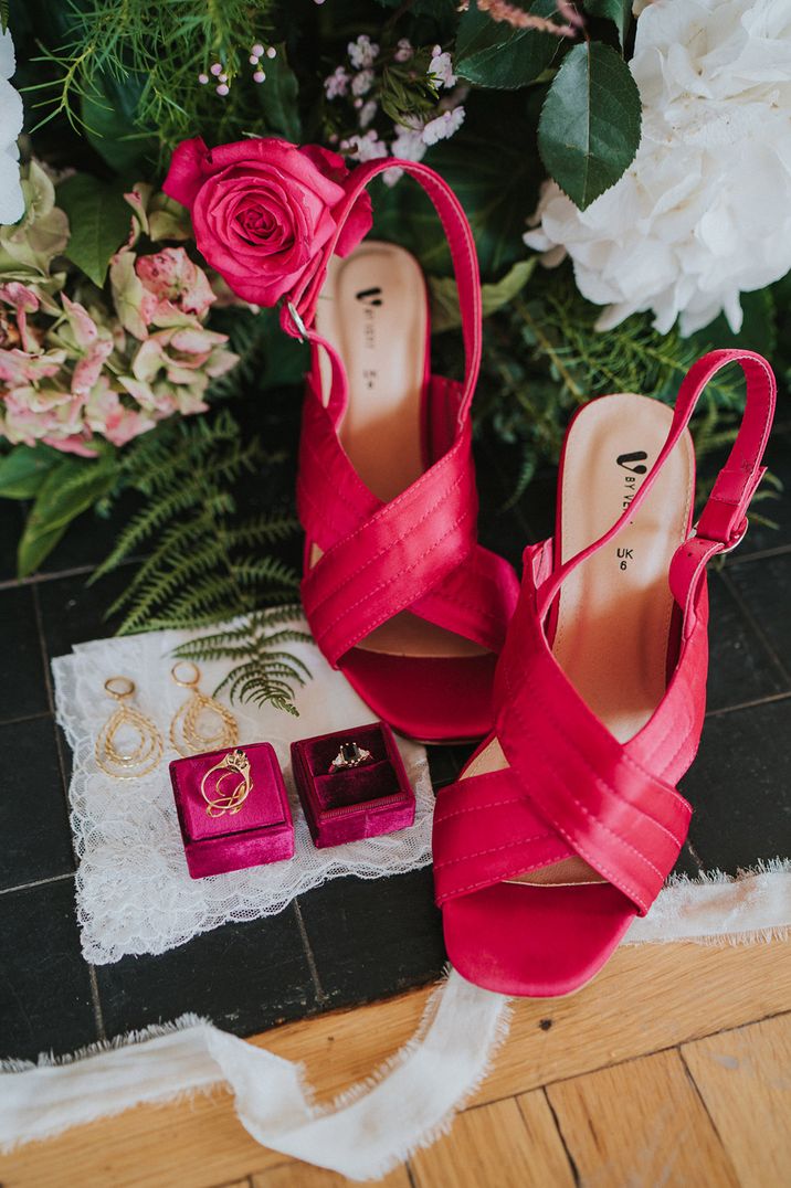 Gold engagement ring and jewellery in pink box with pink wedding shoes 