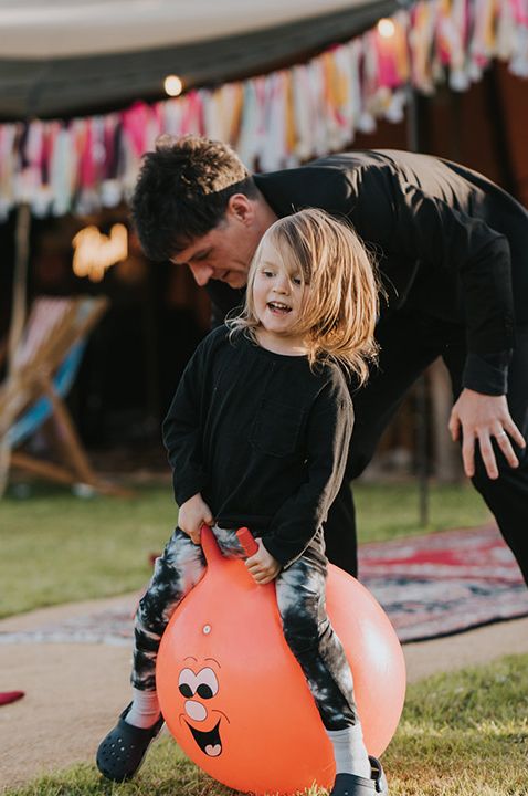 Little wedding guest playing on space hopper for entertainment - how to manage kids at weddings 