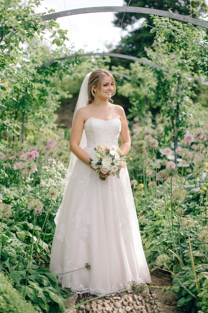 Traditional strapless princess wedding dress with lace detailing by M and J Photography