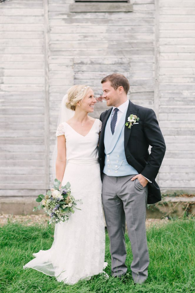 Bride in a A line wedding dress with cap sleeves and groom in a morning suit for rustic wedding 