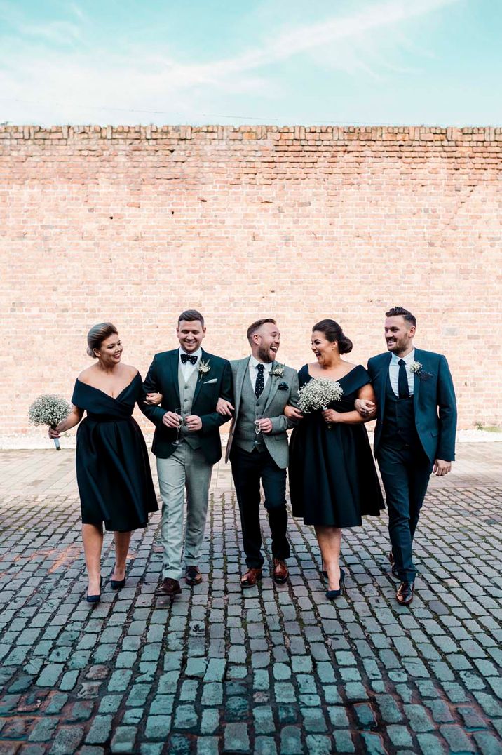 Wedding party in light grey and teal green suits serves as perfect gay wedding inspiration 