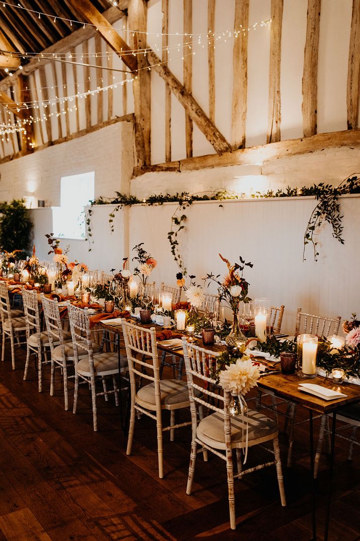 Rustic barn Hertfordshire wedding venue with orange autumnal theme wedding table decor 