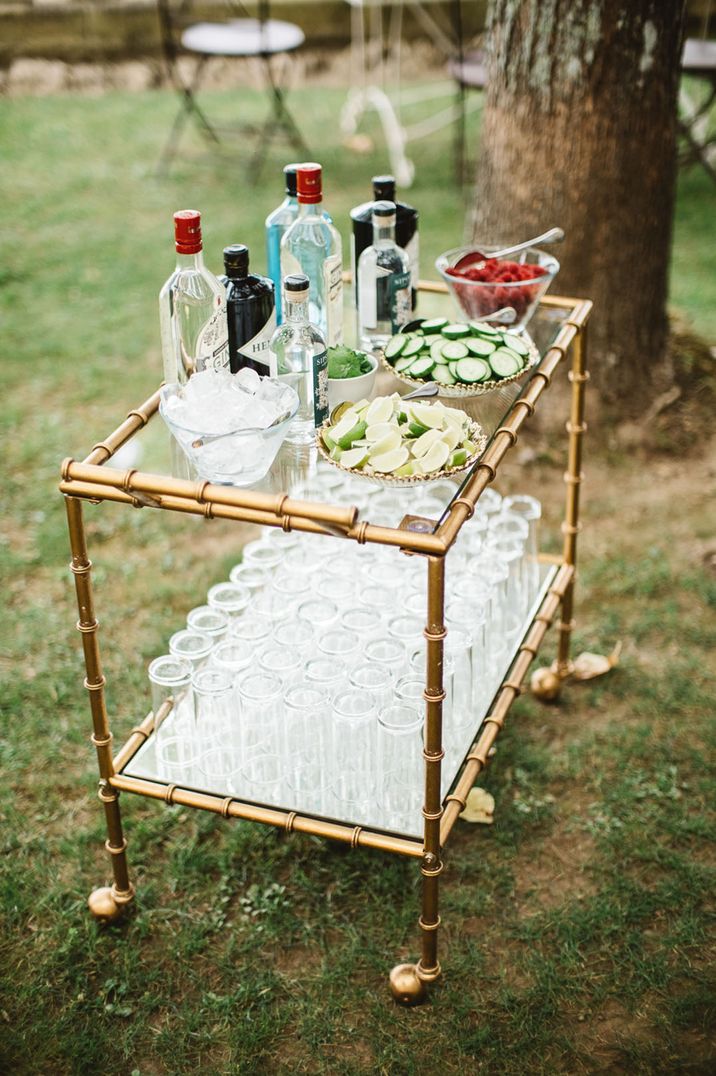 Pimp your drink station unique wedding bar design idea with cart filled with different garnishes, and ice for wedding guests 