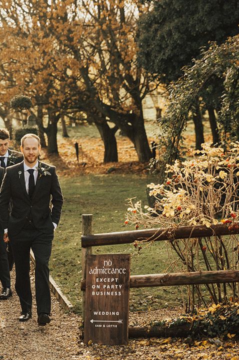 The groom and groomsmen walking together as a group 